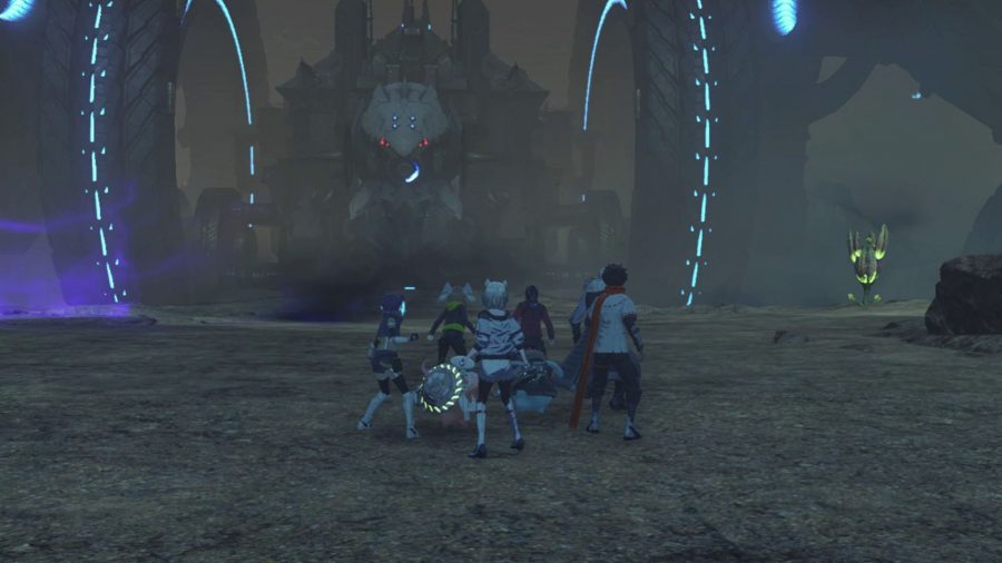 Wielu członków drużyny Xenoblade Chronicles 3, stojących na piaszczystej równinie, patrzących na gigantyczny pojazd mechaniczny z dwoma gigantycznymi, wydrążonymi kołami po obu stronach kulistego ciała.